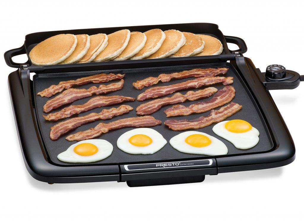 Electric griddle with eggs, bacon and pancakes