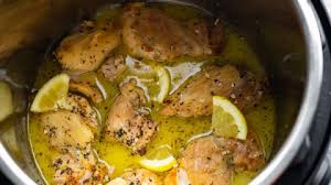 Chicken thigh with spices and lemon pieces in an instant pot